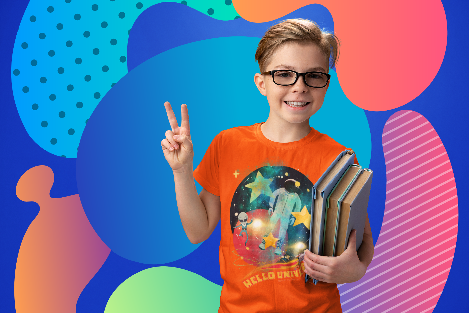 A smiling boy with glasses, wearing an orange T-shirt featuring an astronaut, holds a stack of books in one hand and makes a peace sign with the other. The background has colorful, abstract shapes and patterns in blue, green, and pink tones.