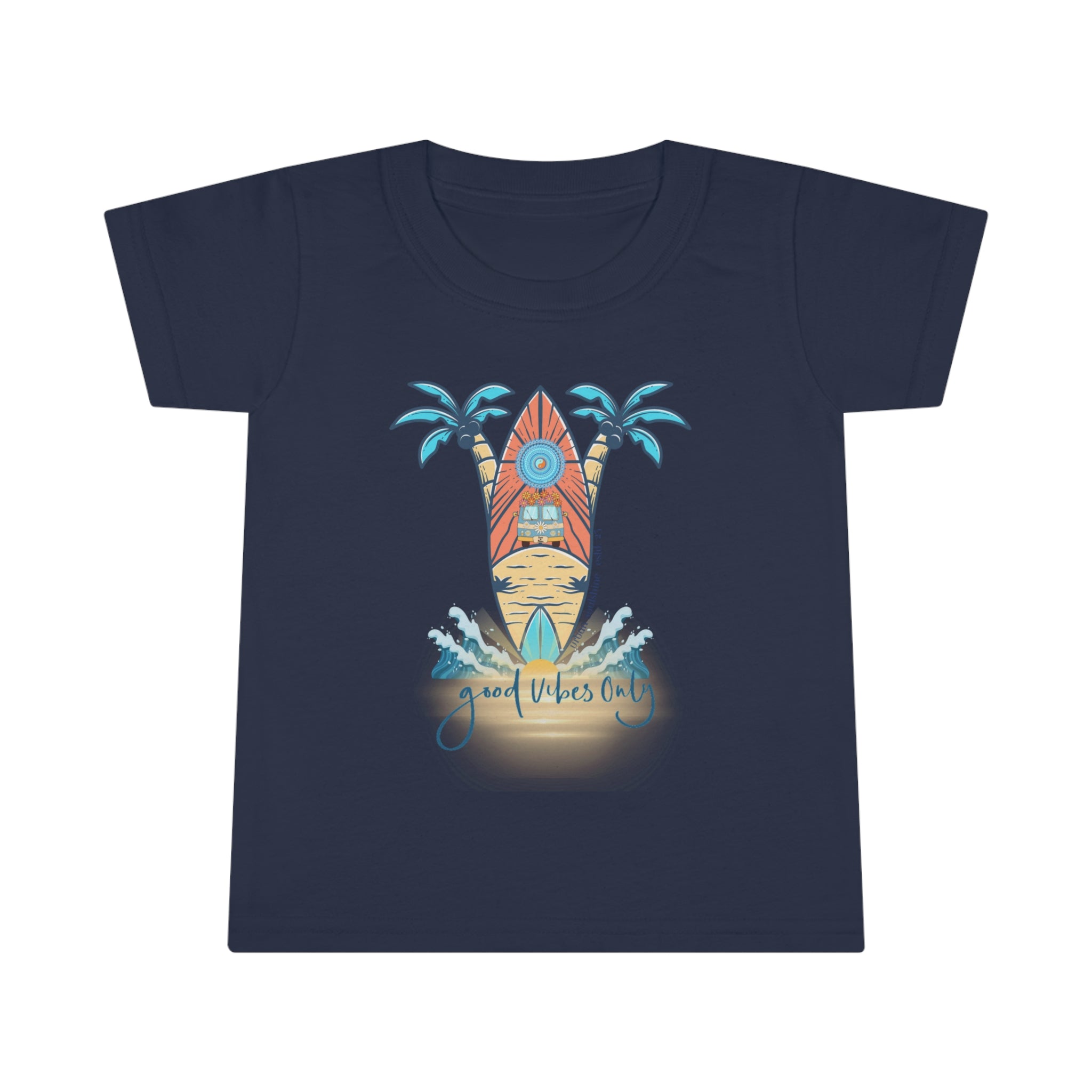 A smiling toddler with light brown hair is wearing a Surf's Up Good Vibes Only Toddler T-shirt by Printify featuring a colorful surfboard design with palm trees and waves. The text "good vibes only" is printed below the surfboard, capturing the spirit of inspirational wear. The child stands against a plain background.