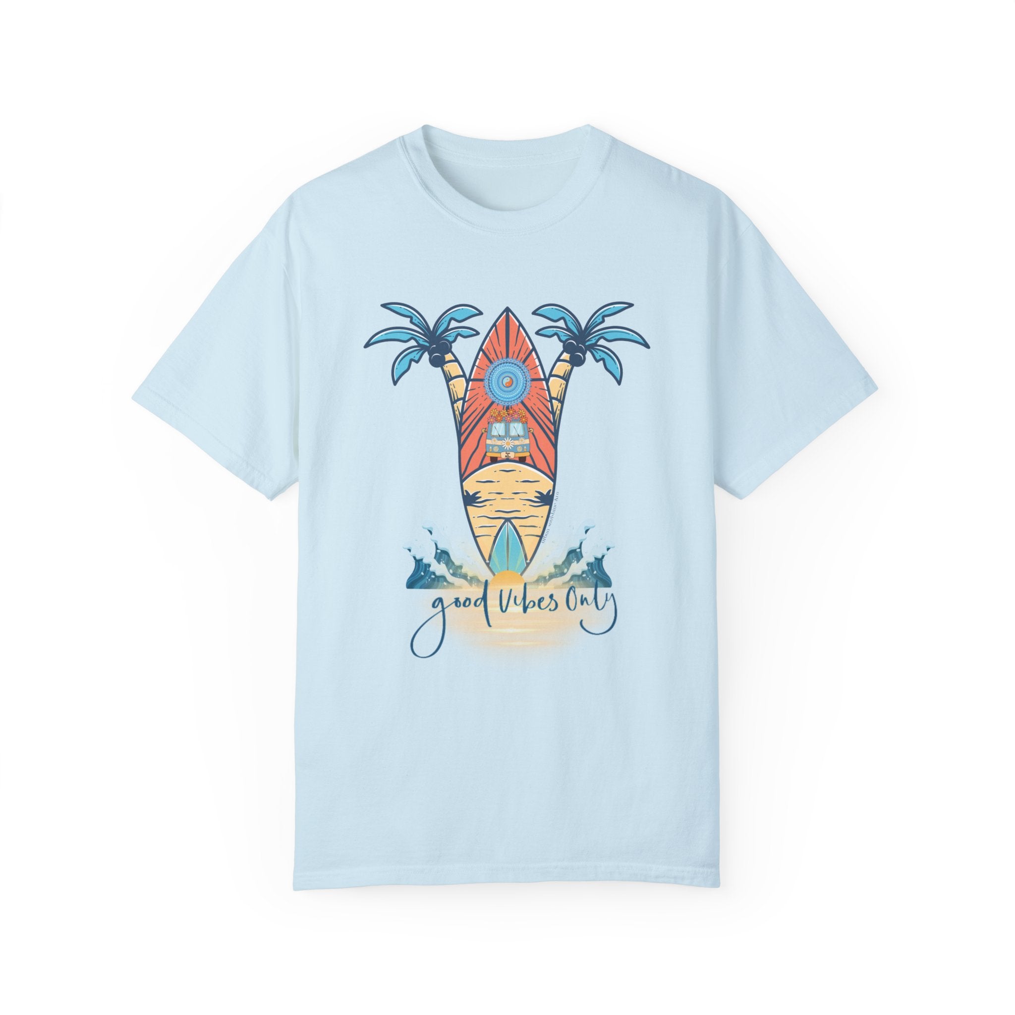 The Surf's Up! Good Vibes Only Tee (Unisex) from Printify is a light blue t-shirt that features a graphic of a surfboard with sun rays behind it, flanked by two palm trees. Below the surfboard are two dolphins and the text "Good Vibes Only" in an artistic font, making it perfect for those who dare to inspire.