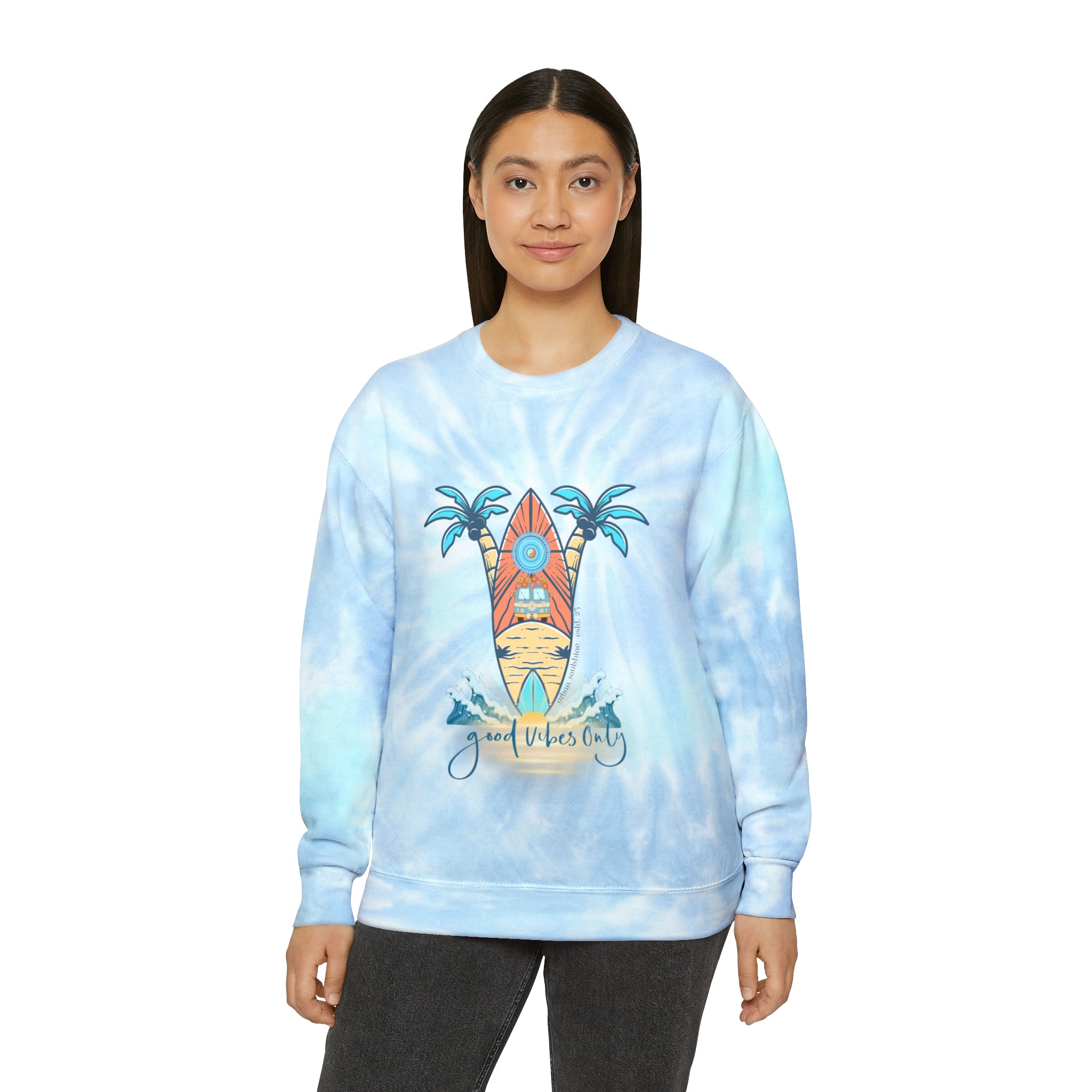 A person with long dark hair is wearing the Urban SoulShine & co Surf's Up Good Vibes Only Tie-Dye Sweatshirt (unisex) featuring a graphic of a surfboard, palm trees, and the words "good vibes only" on the front. Made from pre-shrunk PFD cotton, they are standing against a plain white background.