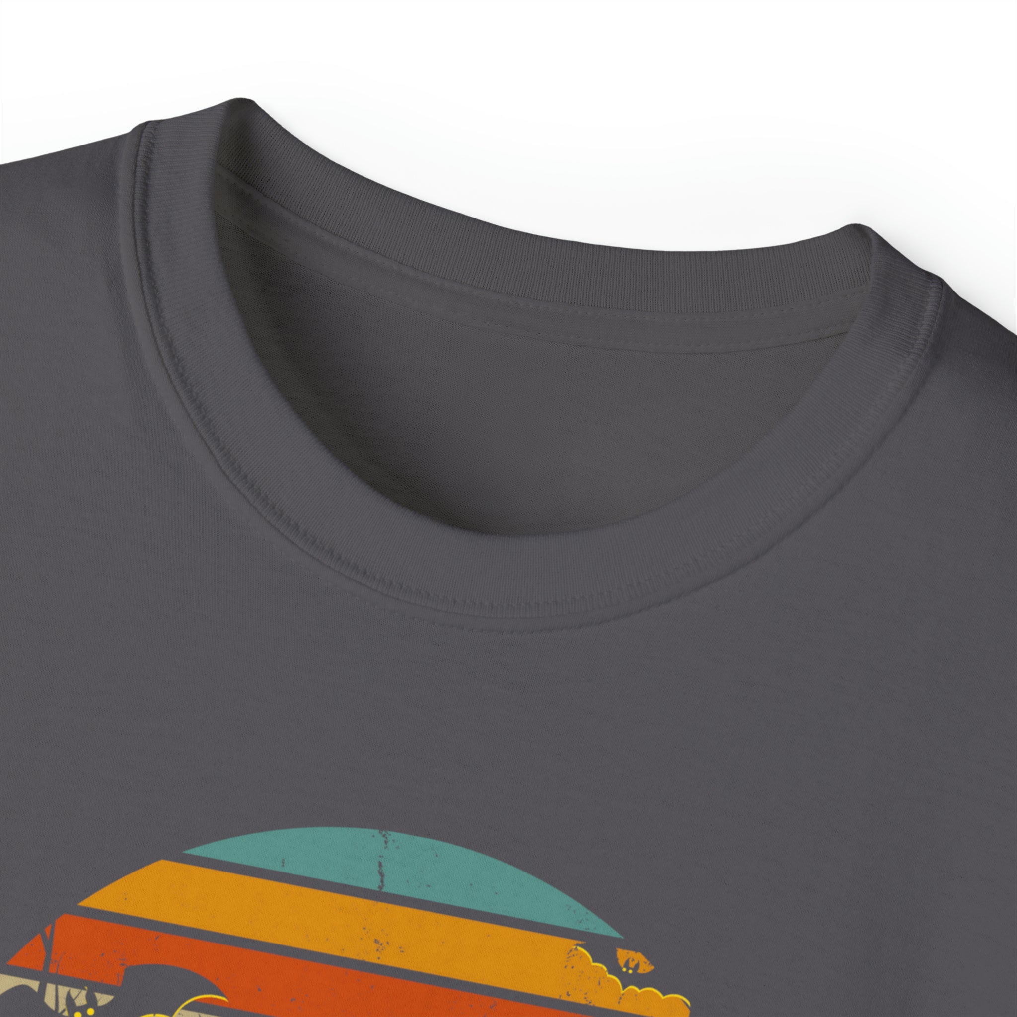 Close-up of a gray Spooky Nights Halloween Ultra Cotton Tee (Unisex) by Printify showing a rainbow-colored, semi-circle graphic printed near the collar. The graphic features five stripes in descending order of red, orange, yellow, teal, and dark blue. This inspirational wear emphasizes the collar and chest area of the t-shirt.