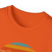 Close-up of an orange Spooky Nights Halloween Ultra Cotton Tee (Unisex) by Printify with a visible neckline and a partial view of an artistic expression on the chest. The graphic showcases vibrant colors like blue and yellow. The t-shirt is laid flat against a white background, radiating soulshine.