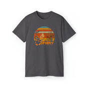 The Spooky Nights Halloween Ultra Cotton Tee (Unisex) by Urban SoulShine & co is a dark grey shirt highlighted with a round Halloween-themed graphic in the center. The design showcases an orange and yellow sunset, a haunted house, bats, trees, and graveyard silhouettes. Crafted from sustainable materials for a comfy fit, the word "SPOOKY" is inscribed at the bottom in orange letters.