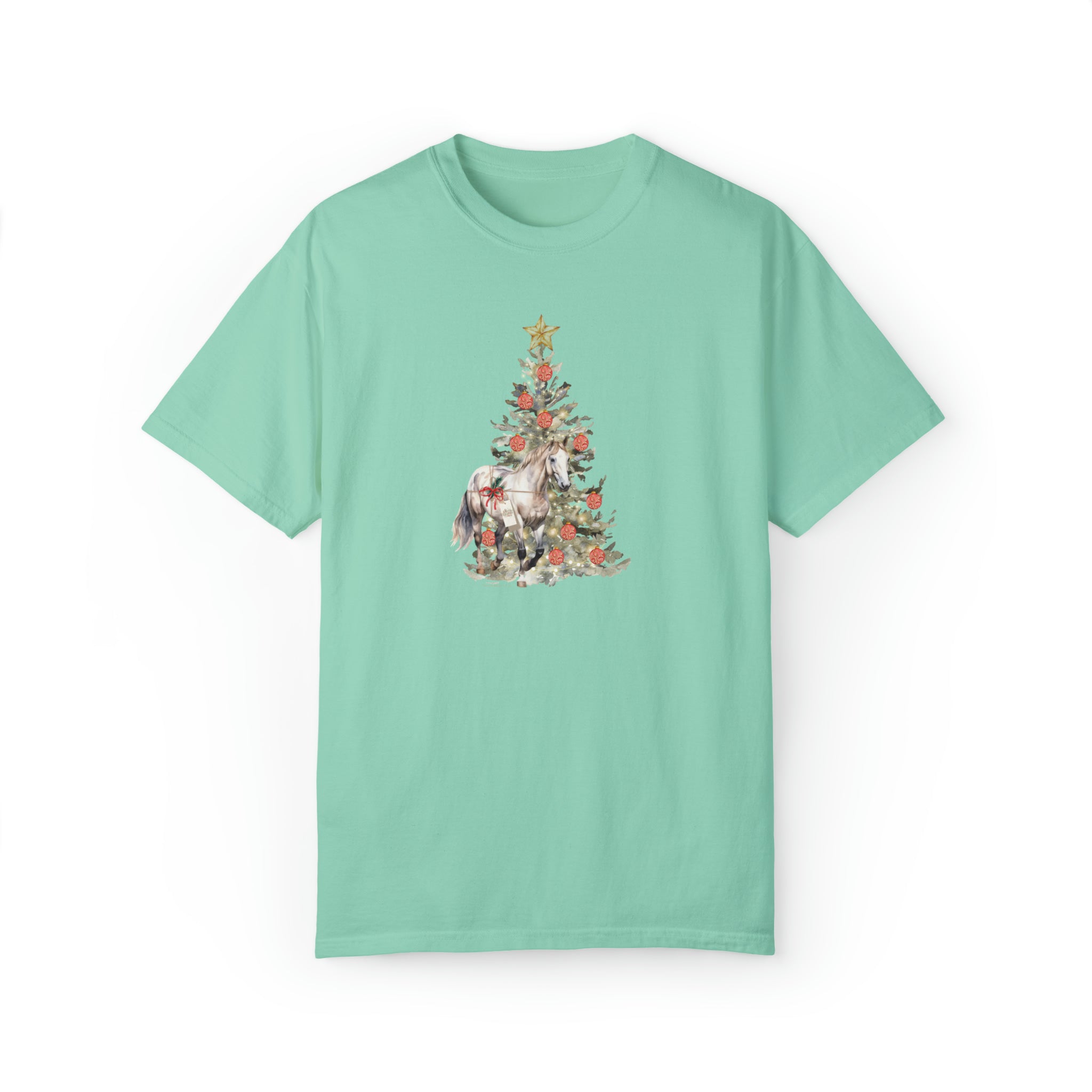 Introducing "The Gift of A Horse Christmas Garment-Dyed T-shirt" by Urban SoulShine & co, featuring a light green garment-dyed design with a Christmas tree embellished with a star and floral accents. A whimsical watercolor unicorn gracefully stands before the tree, all crafted from soft ring-spun cotton. Set against a plain white background, this shirt is perfect for the festive season.