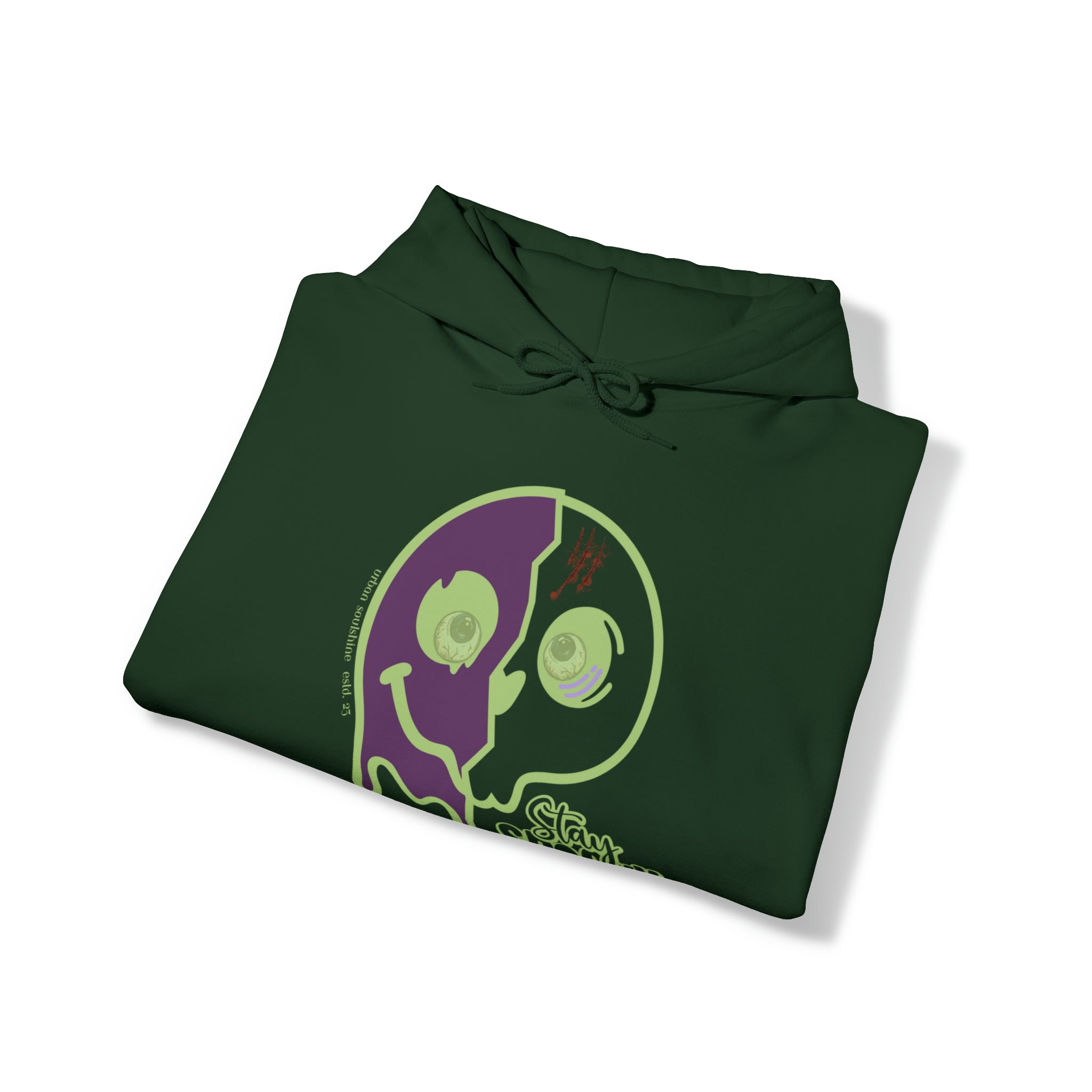 Dark green hoodie with a folded design, featuring a graphic of a half purple, half green broken smiley face with abstract detailing on the front. The smiley face has two mismatched eyes and a small text line on the left side. Perfect for those who want to express themselves through artistic expression. Introducing the Stay Spooky Funky Faces Halloween Hoodie (unisex) by Printify.