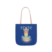 A blue tote bag with light beige handles features a design of a surfboard on a sandy beach with palm trees and waves. The text "Good Vibes Only" is written below the design in stylized font, making it perfect for those who dare to inspire. This is the Surf's Up Good Vibes Only Beach Tote by Printify.