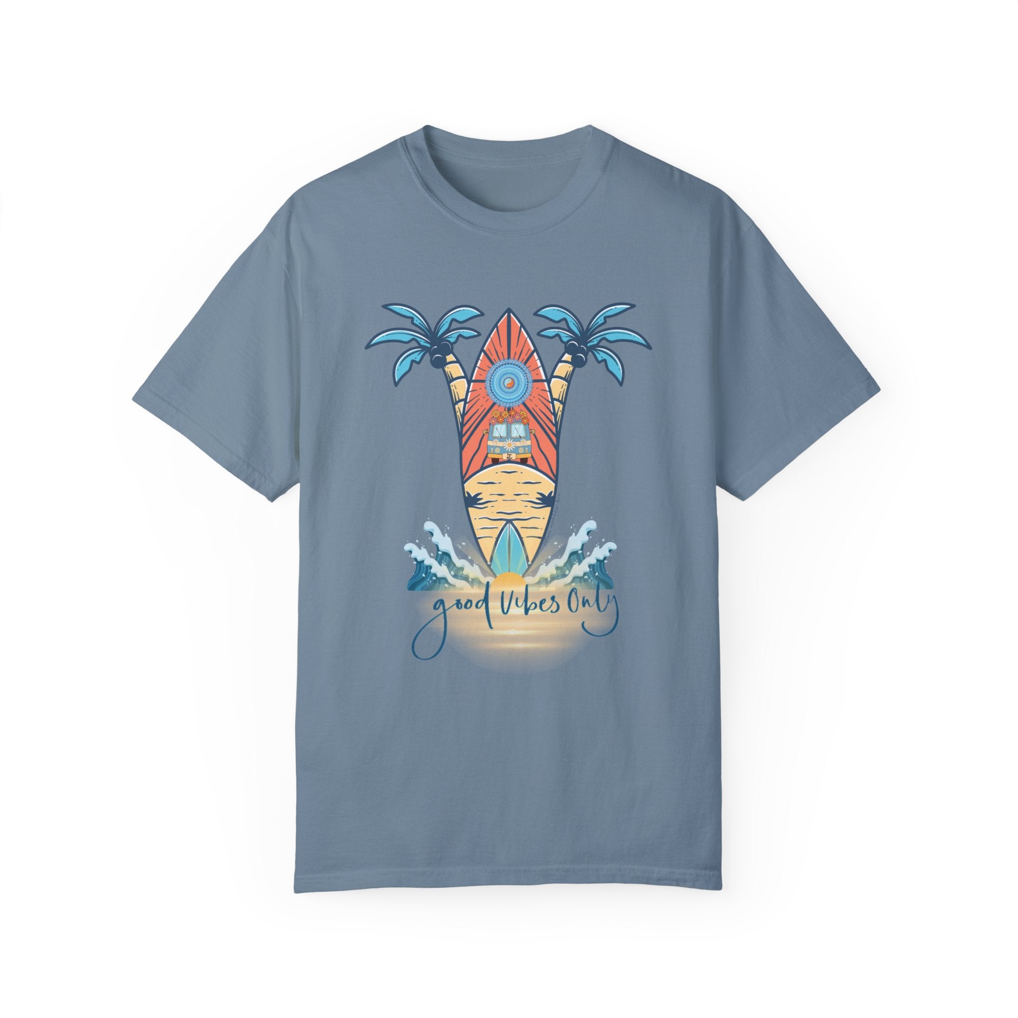 A light blue Surf's Up! Good Vibes Only Tee (Unisex) by Printify with a graphic design featuring two palm trees, a surfboard with a sunset and beach scene in the background, and the text "Good Vibes Only" at the bottom. Small ocean waves around the base of the surfboard add to its soulshine aesthetic.