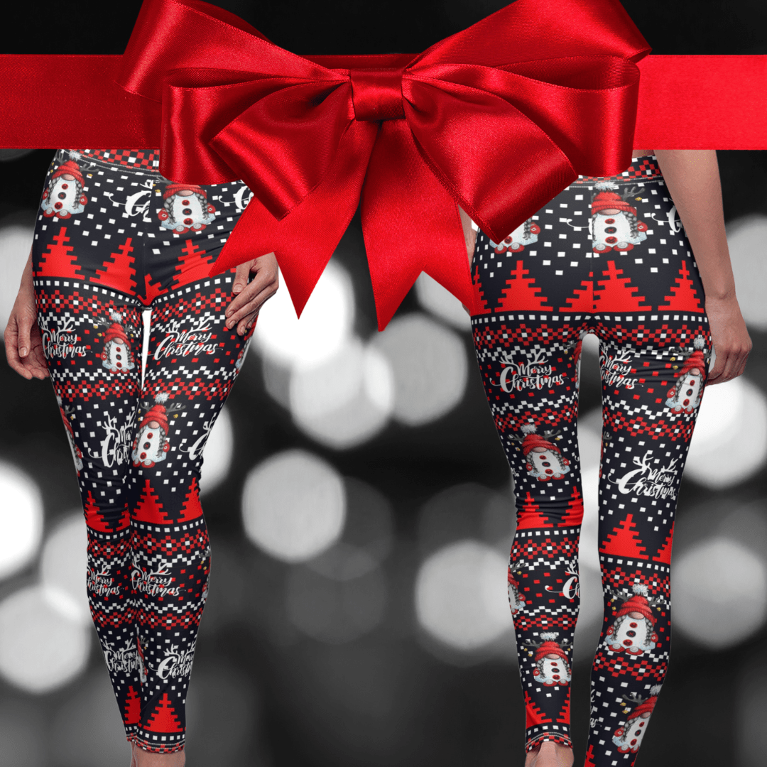 The Merry Christmas Reindeer Gnome SuperSoft Casual Leggings from Urban SoulShine & co feature a festive design with snowmen, red trees, and "Merry Christmas" text on a suede-like fabric. A large red ribbon and bow adorns the top, while the backdrop is enhanced by a grayscale bokeh effect reminiscent of traditional Christmas sweaters.