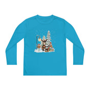 This Donkey Claus Street Player Christmas Long Sleeve Competitor Tee by Urban SoulShine & Co features a whimsical scene of a bear playing guitar among snow-covered trees and a streetlamp, all while providing comfort with its PosiCharge moisture-wicking technology.