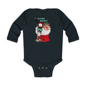 This dark green long sleeve onesie, crafted by Urban SoulShine & co, features the playful Donkey Claus design with a donkey wearing a Santa hat and goggles, cheerfully carrying vibrant presents. Above the scene, the text whimsically asks, "Do You Hear What I Hear?