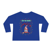 The Urban SoulShine & co "Deck The Gnomes Christmas Toddler Long Sleeve Tee" features a whimsical gnome in a red-striped hat adorned with Christmas lights on 100% cotton blue fabric. Above the cheerful gnome, the text "Deck the Gnomes" adds festive flair, while red ornaments and lights elegantly frame the design.