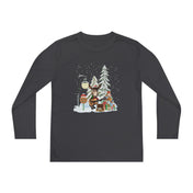 Introducing the Urban SoulShine & co Donkey Claus Street Player Christmas Long Sleeve Competitor Tee for youth, featuring a festive design with a snow-covered street lamp, a reindeer holding a "Noel" sign, and a Christmas tree surrounded by wrapped presents. Crafted with PosiCharge technology for moisture-wicking comfort, it beautifully captures snowflakes gently falling in the scene.