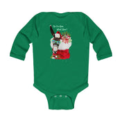 The "Do You Hear What I Hear Donkey Claus Long Sleeve Onesie" from Urban SoulShine & co features a llama sporting sunglasses and a Santa hat, cozy inside a Christmas stocking. The playful text by the llama's head adds to this green infant bodysuit's festive charm and whimsical design.