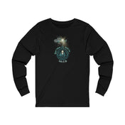 The Urban SoulShine & co "Good Tidings Great Joy Christmas Wish Glowing Long Sleeve Tee" is a unisex black shirt showcasing a festive design with a starburst or firework graphic above a circular motif. It features the phrase from Luke 2:10, "Good Tidings of Great Joy.