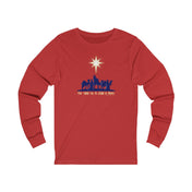 The Urban SoulShine & co "For Unto Us A Child Is Born Christmas Long Sleeve Tee" unisex shirt is expertly crafted from premium Airlume combed cotton. It features a festive design with a red shirt adorned with silhouettes of three camels, figures, and a star above, alongside the text "For Unto Us A Child Is Born.