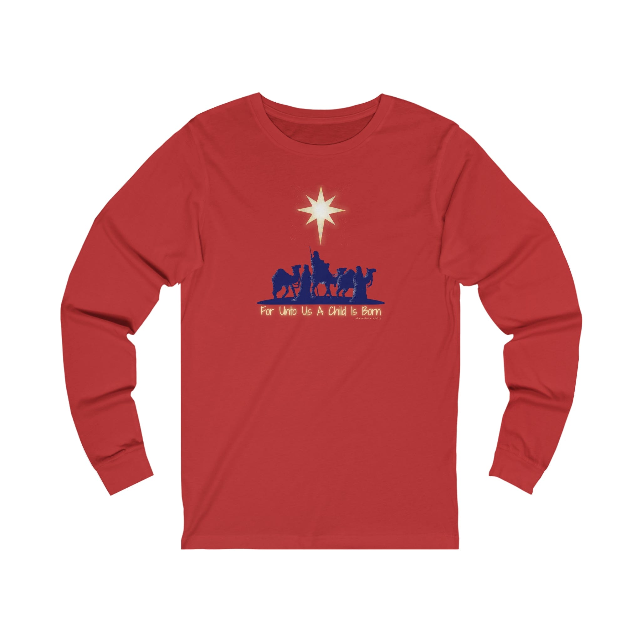 The Urban SoulShine & co "For Unto Us A Child Is Born Christmas Long Sleeve Tee" unisex shirt is expertly crafted from premium Airlume combed cotton. It features a festive design with a red shirt adorned with silhouettes of three camels, figures, and a star above, alongside the text "For Unto Us A Child Is Born.