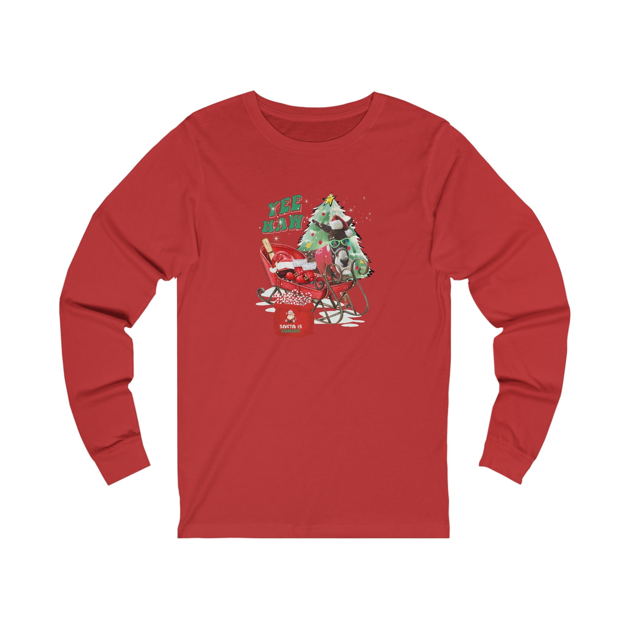 The YEE HAW Santa Is Coming Donkey Claus Long Sleeve Tee by Urban SoulShine & co is a unisex red jersey shirt that showcases a festive cartoon Christmas scene. It features a green monster decorating a tree alongside a sleigh brimming with presents, capturing the charm of the holiday season. The text reads "YEE HAW.