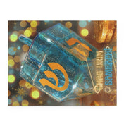 The Happy Festival Of Lights Hanukkah Jigsaw Gift Puzzle from Urban SoulShine & co features a close-up of a blue dreidel with orange Hebrew letters, meticulously crafted from high-quality chipboard. Its warm bokeh background showcases golden coins, while the "Happy Chanukah" text glows in yellow, making it an ideal holiday gift.