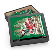 The box of the Long Ear Christmas Tree Farm Donkey Claus Jigsaw Puzzle by Urban SoulShine & Co is open, showing a partially completed puzzle inside. Made from high-quality chipboard, the box features a festive image of a red truck accompanied by a snowman and Christmas trees against a green background. The label indicates it as "16x20 Puzzle, 500 pcs, Ages 7+," ready to be gifted.
