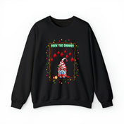 Introducing the Urban SoulShine & co Deck The Gnomes Holiday Crewneck Sweatshirt for unisex wear. This cozy black sweatshirt features a vibrant illustration of a gnome wearing a red and white striped hat, complemented by the playful "Deck the Gnomes" text embellished with hanging red ornaments and surrounded by multicolored lights. Crafted from a soft polyester-cotton blend, it's perfect for festive fun.