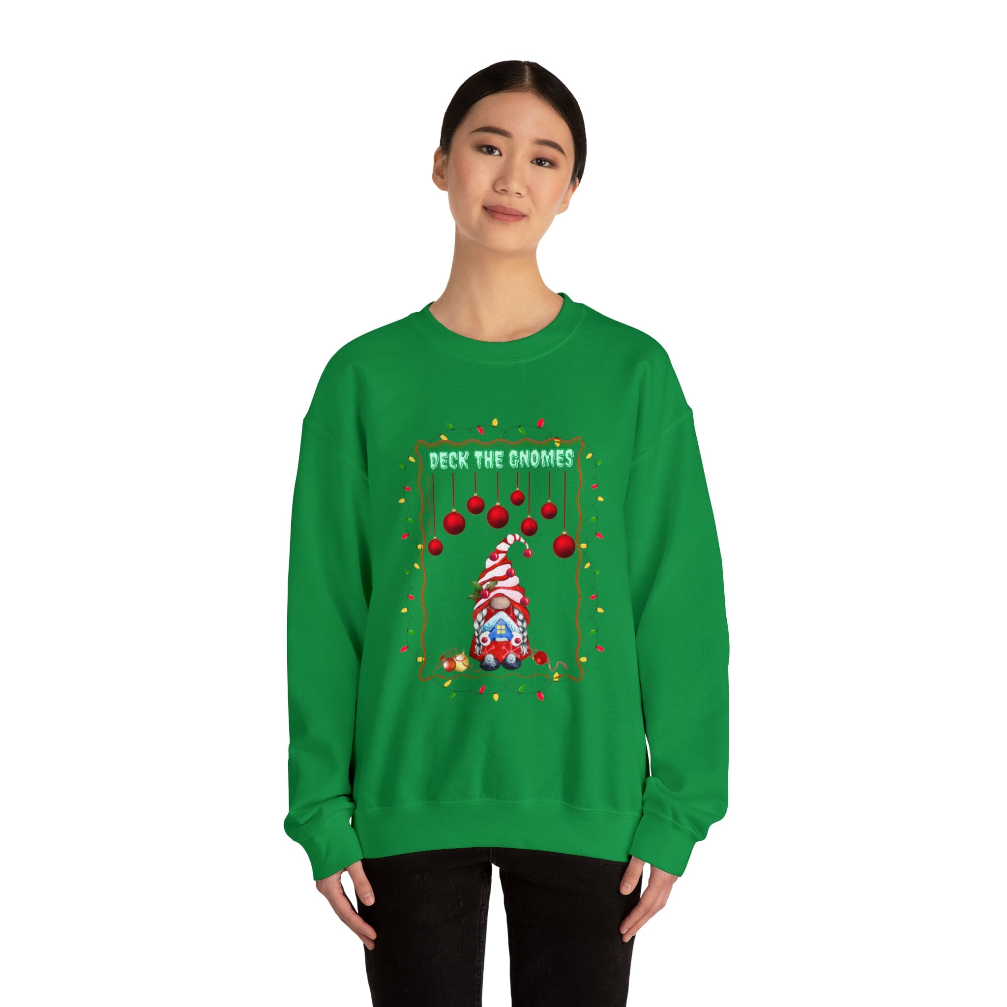 A person wearing Urban SoulShine & co's "Deck The Gnomes" Holiday Crewneck Sweatshirt in a green polyester cotton blend showcases a festive design featuring a gnome and ornaments. The unisex sweater displays the phrase "Deck the Gnomes" against a white background.